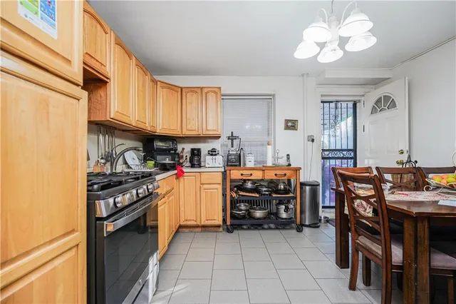 a kitchen with cabinets and chairs