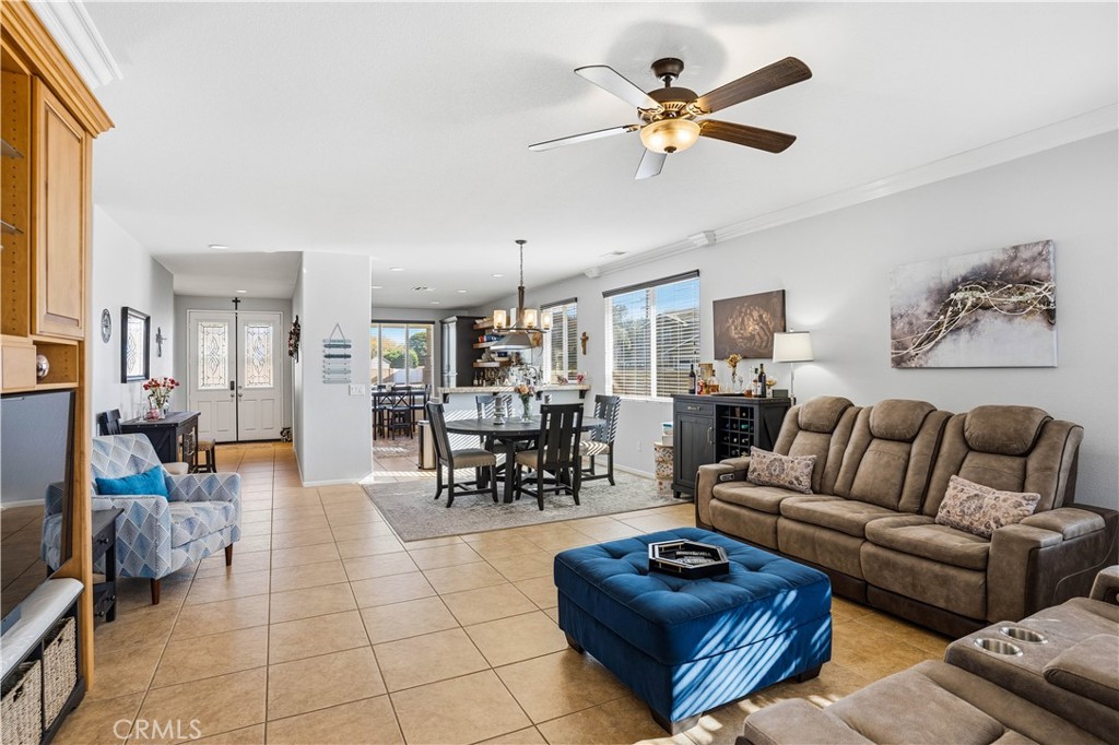 29183 Paperflower Lane Menifee, CA 92584 - Photo 13 of 49 a living room with furniture a ceiling fan and a rug