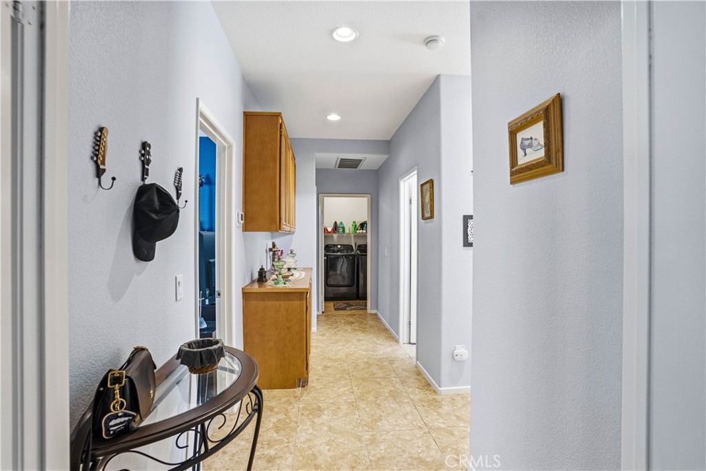29183 Paperflower Lane Menifee, CA 92584 - Photo 14 of 49 a view of a hallway with couch and dining area