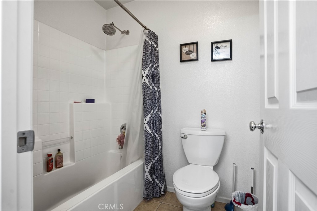 29183 Paperflower Lane Menifee, CA 92584 - Photo 17 of 49 a white toilet sitting next to a bath tub