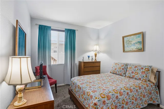 a bedroom with bed and window