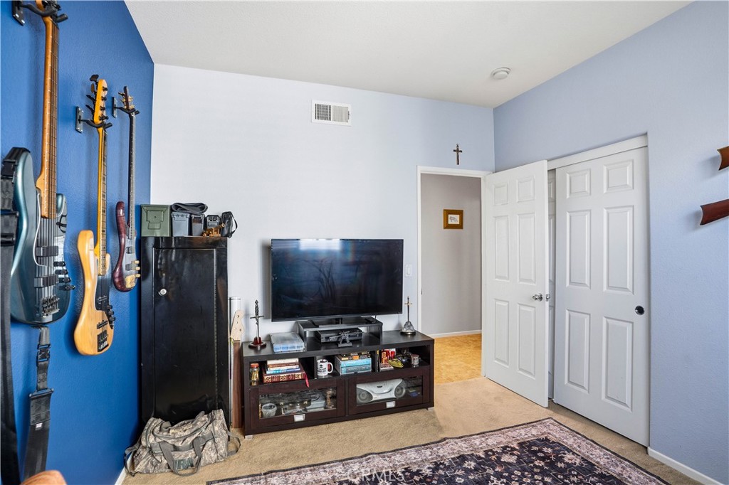 29183 Paperflower Lane Menifee, CA 92584 - Photo 21 of 49 a living room with furniture and a flat screen tv