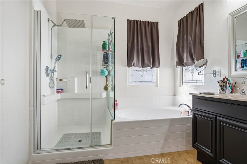 29183 Paperflower Lane Menifee, CA 92584 - Photo 26 of 49 a bathroom with a tub sink and mirror