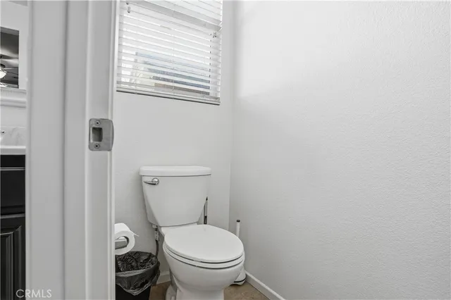 a white toilet sitting next to a window