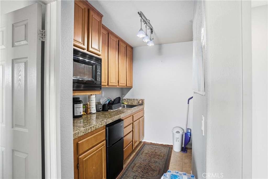 29183 Paperflower Lane Menifee, CA 92584 - Photo 31 of 49 a kitchen with stainless steel appliances granite countertop a refrigerator and a stove top oven