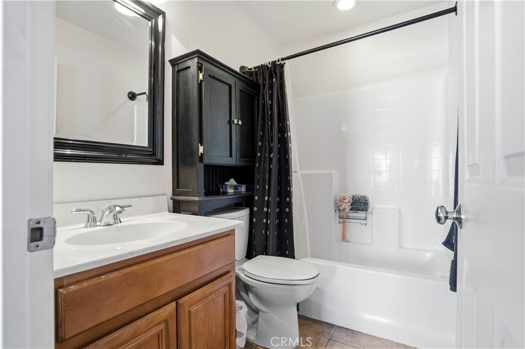 29183 Paperflower Lane Menifee, CA 92584 - Photo 34 of 49 a bathroom with a sink a toilet and shower