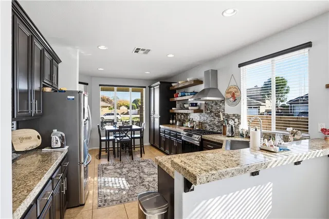 a kitchen with a stove and a refrigerator