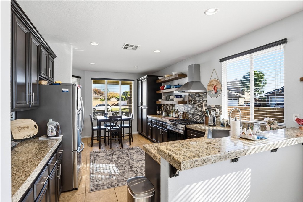 29183 Paperflower Lane Menifee, CA 92584 - Photo 6 of 49 a kitchen with a stove and a refrigerator