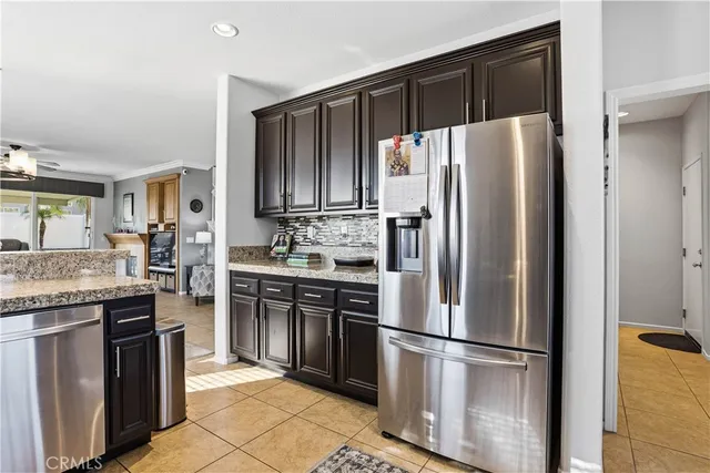 a kitchen with stainless steel appliances granite countertop a refrigerator stove a sink and a granite counter tops