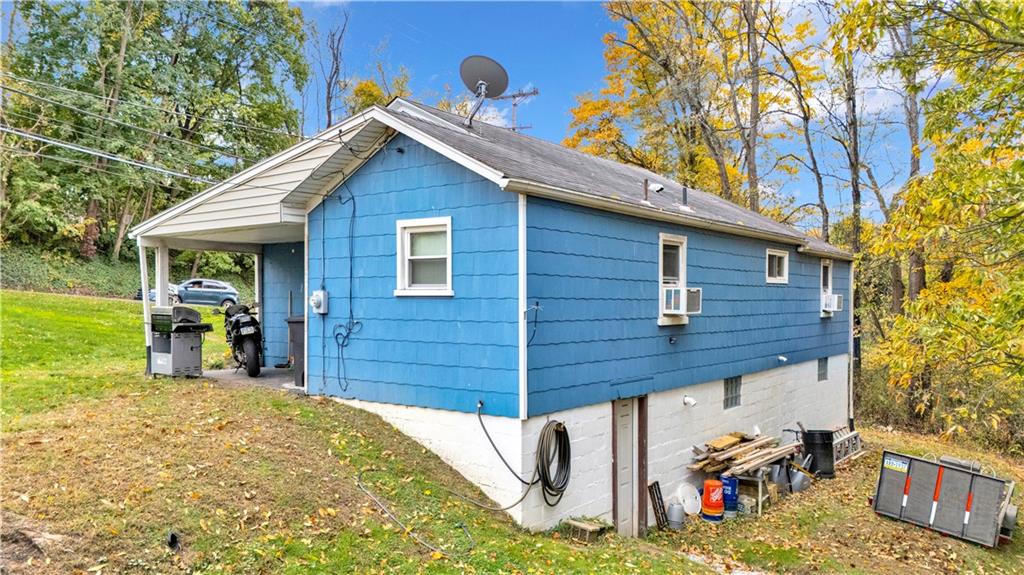 1004-1006 Gringo Road Aliquippa, PA 15001 - Photo 4 of 7 a view of a backyard with a large tree