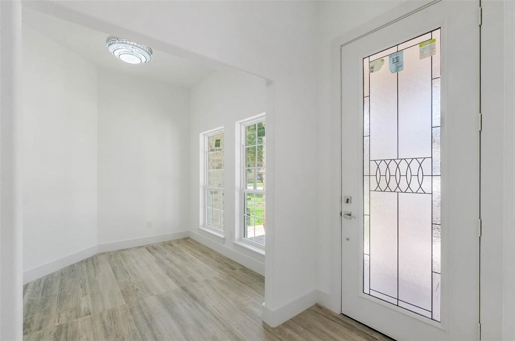 2291 Riverside Drive West Columbia, TX 77486 - Photo 19 of 50 an empty room with wooden floor and windows