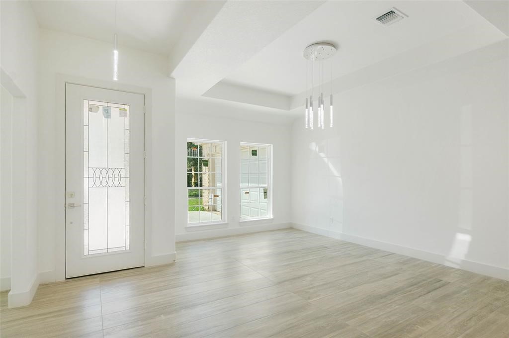 2291 Riverside Drive West Columbia, TX 77486 - Photo 21 of 50 a view of an empty room with wooden floor and a window