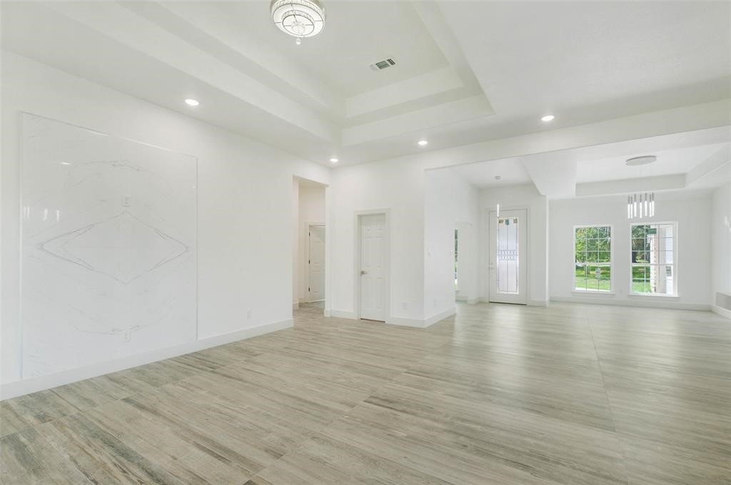 2291 Riverside Drive West Columbia, TX 77486 - Photo 32 of 50 a view of an empty room with wooden floor and a window