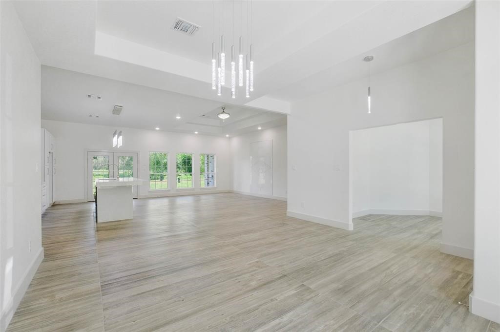 2291 Riverside Drive West Columbia, TX 77486 - Photo 34 of 50 a view of an empty room with wooden floor kitchen view and a window