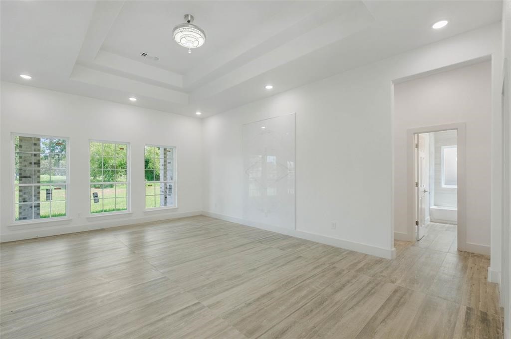 2291 Riverside Drive West Columbia, TX 77486 - Photo 36 of 50 an empty room with wooden floor and windows