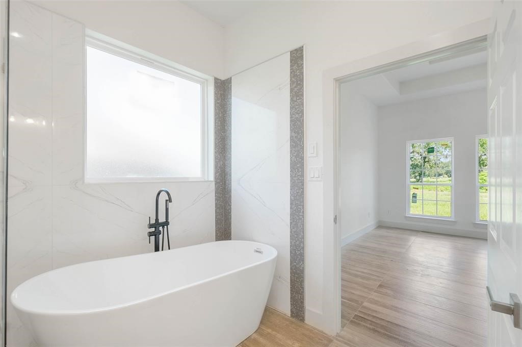 2291 Riverside Drive West Columbia, TX 77486 - Photo 40 of 50 a white bath tub sitting in a bathroom next to a window