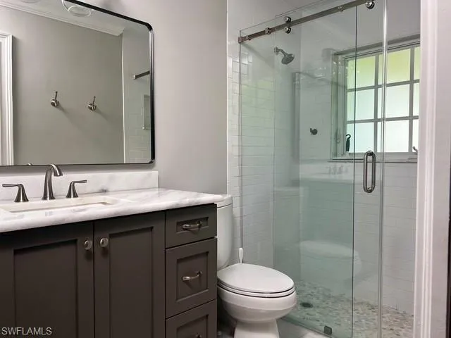 a bathroom with a sink toilet and shower