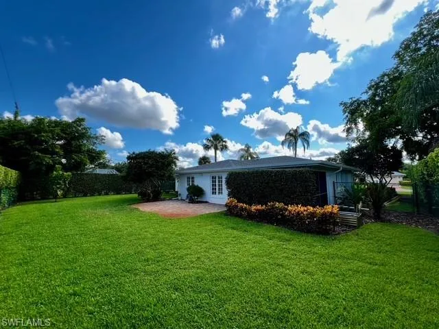 a view of a couches in front of house with a yard