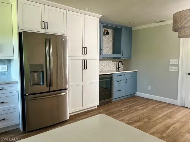 a kitchen with a refrigerator sink and cabinets