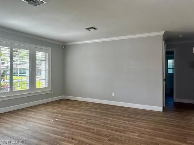 wooden floor in an empty room with a window