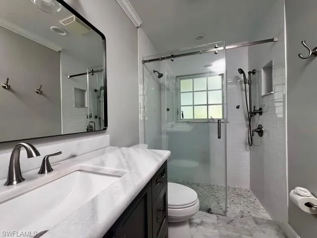 a bathroom with a sink toilet and shower