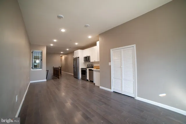 a kitchen with stainless steel appliances granite countertop a refrigerator stove and microwave