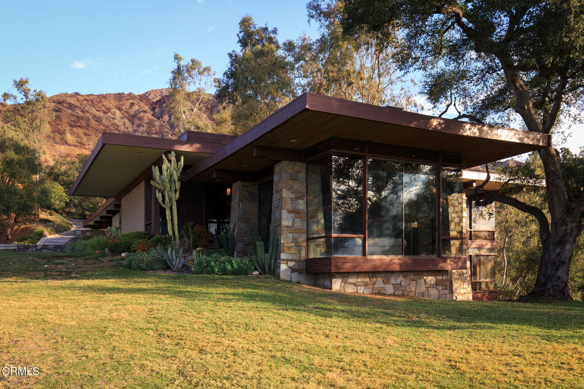 a view of a house with pool and sitting area