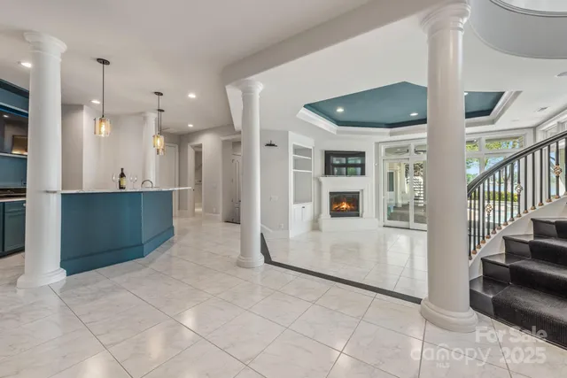 a view of a hallway with kitchen and living room
