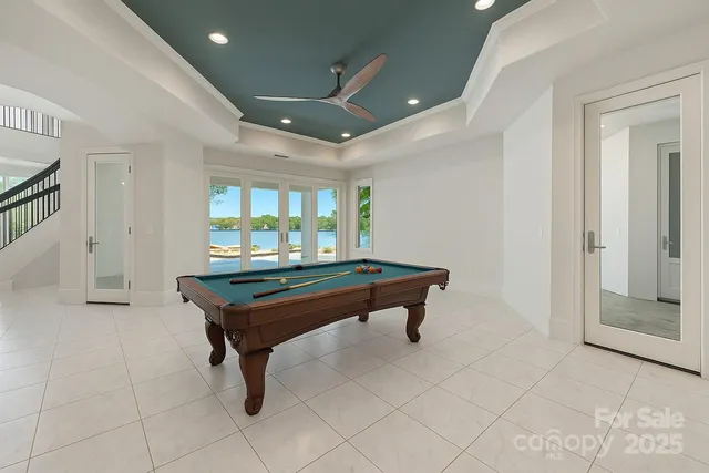 a room with furniture pool table and windows