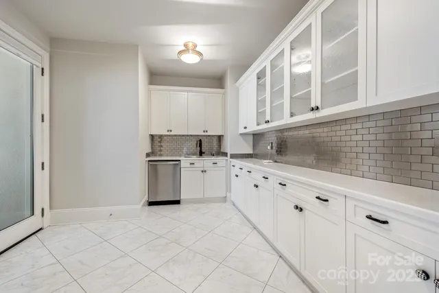 a kitchen with granite countertop white cabinets and white appliances