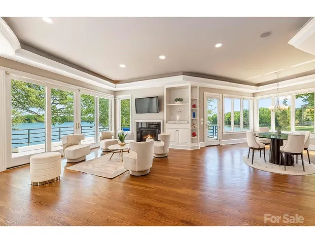 a living room with fireplace furniture and a large window