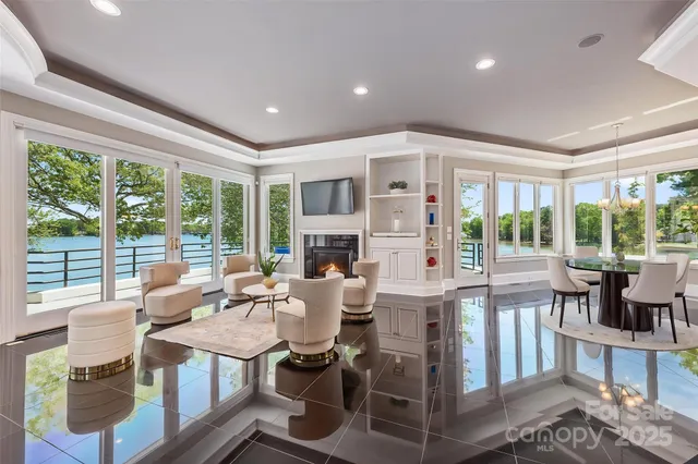 a living room with fireplace furniture and a large window