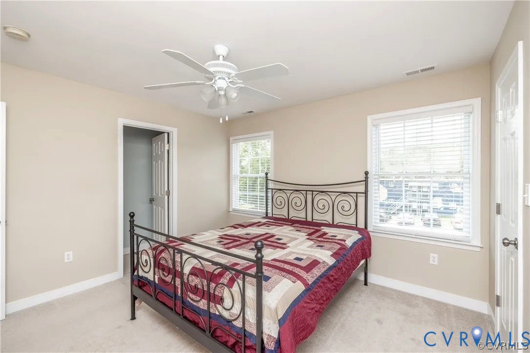 1733 Lakeview Avenue Richmond, VA 23220 - Photo 15 of 28 a bedroom with a bed mirror and a window