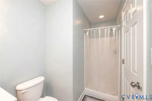a bathroom with a toilet and a shower