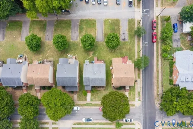an aerial view of residential houses with outdoor space and street view
