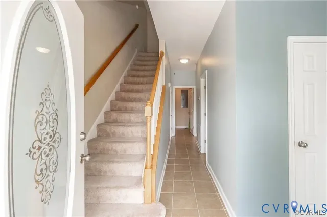 a view of a hallway with wooden floor and entryway