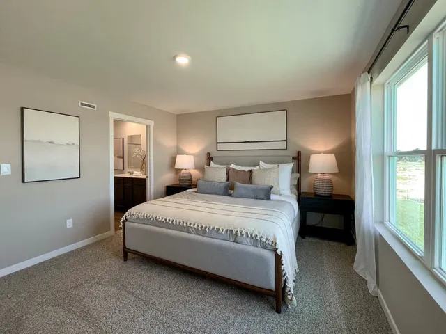 a bedroom with a bed and window