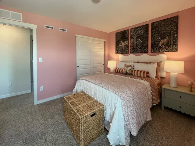 a bedroom with a bed and a window