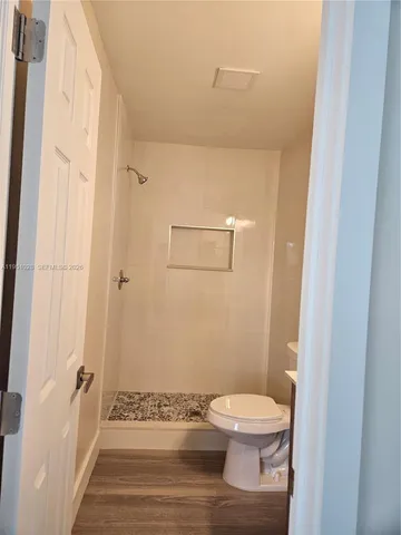 a bathroom with a toilet a sink and shower