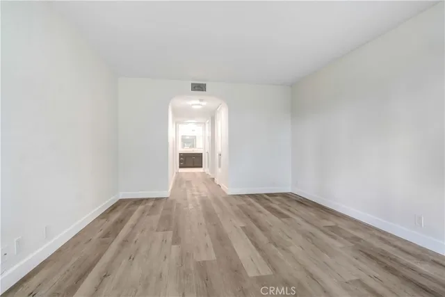 a view of an empty room and wooden floor