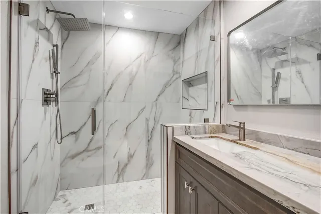 a front view of a house with a yard and tree