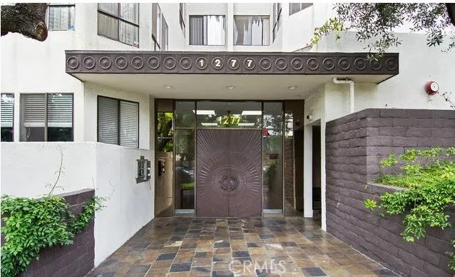 a view of a palm trees front of house with trees