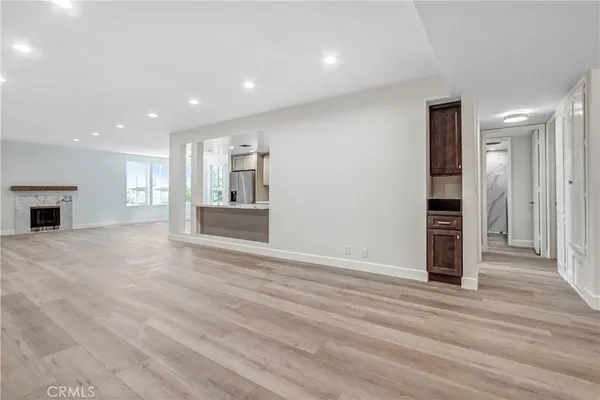 a view of a kitchen with wooden floor and a kitchen