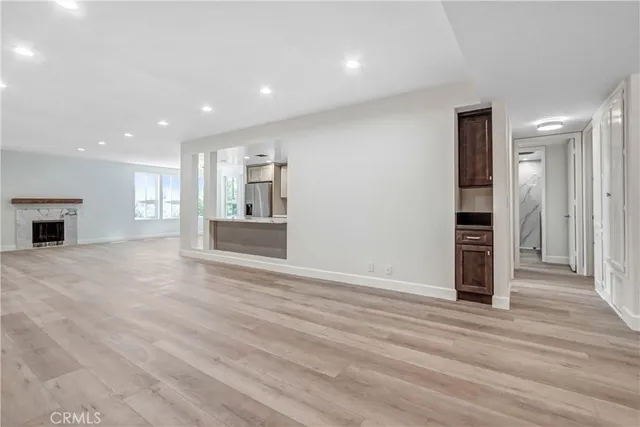 a view of a kitchen with wooden floor and a kitchen