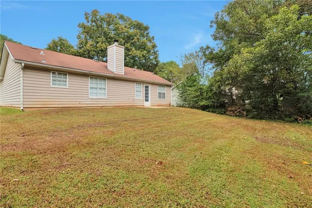 a view of a house with a yard and garage