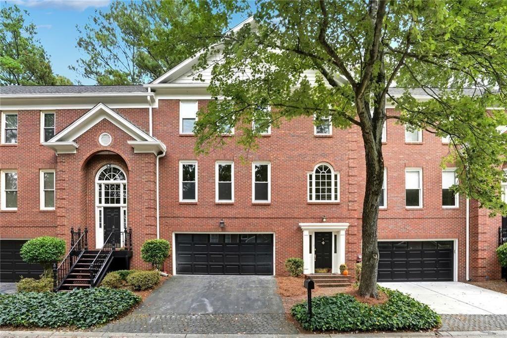 7155 Roswell Road, Unit 9 Sandy Springs, GA 30328 - Photo 1 of 1 a front view of a house with garden