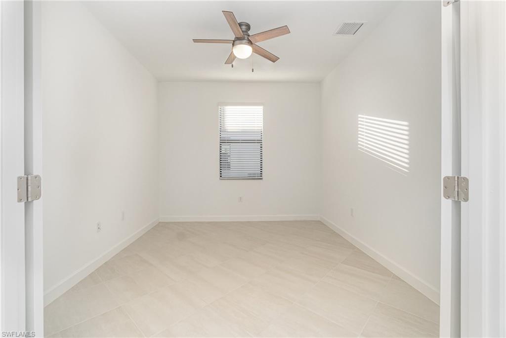 11127 Canopy Loop Fort Myers, FL 33913 - Photo 12 of 29 Spare room with baseboards and a ceiling fan