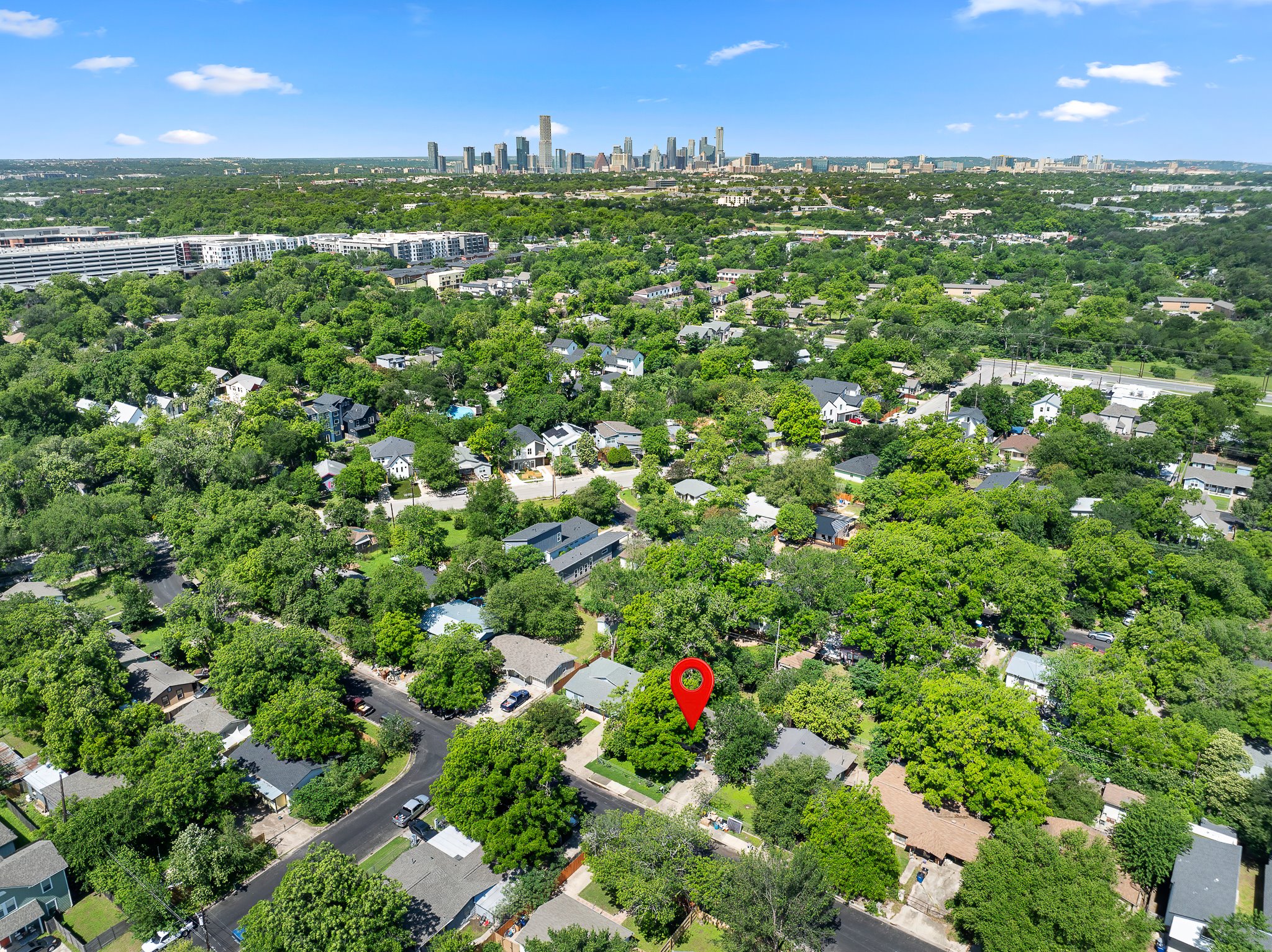 1122 Spur Street, Unit D Austin, TX 78721 - Photo 6 of 6 Aerial perspective showcasing the residential neighborhood with dense tree canopies