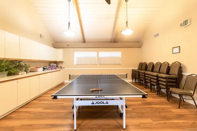 a room with furniture pool table and window