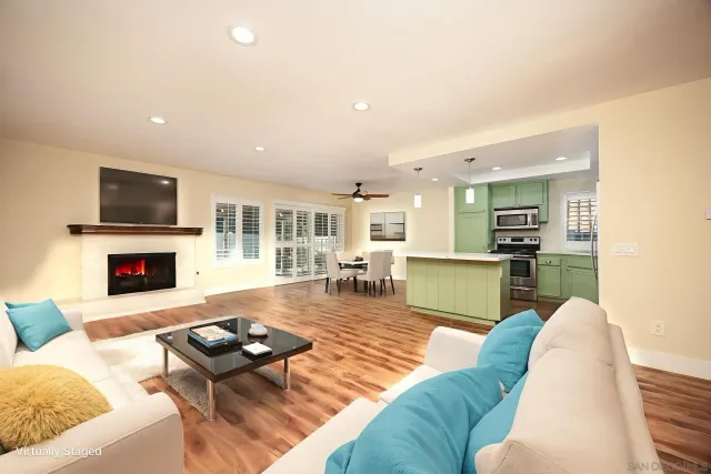 a living room with furniture a fireplace and a flat screen tv